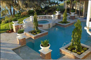 pool landscaping in winter springs florida with a firepit and summer kitchen